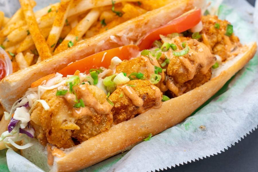 A Po' Boy sandwich with fries